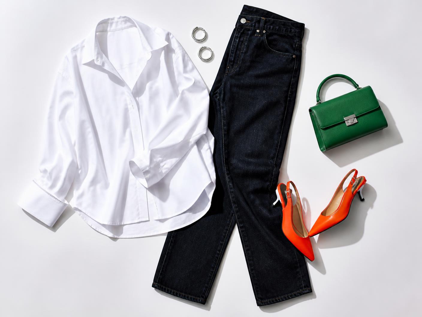 White shirt, dark denim, green bag and orange shoes arranged as a complete look